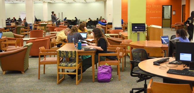 Students at tables in Hillman library