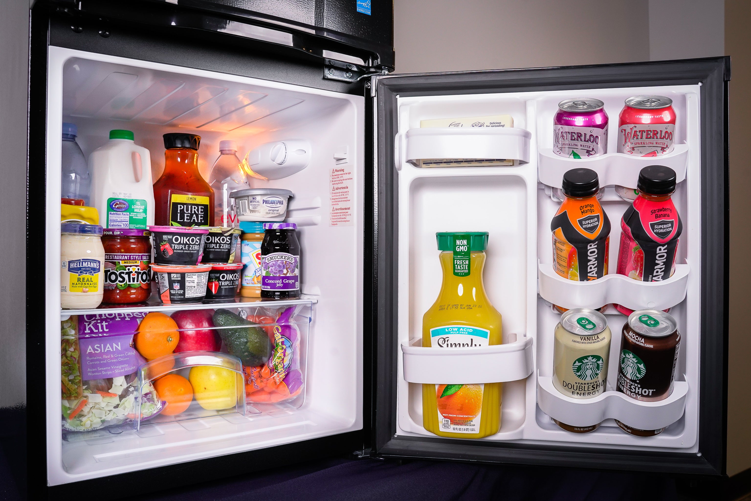 Open mini fridge showing groceries 