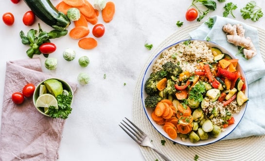 Vegetable and quinoa bowl on white linens 