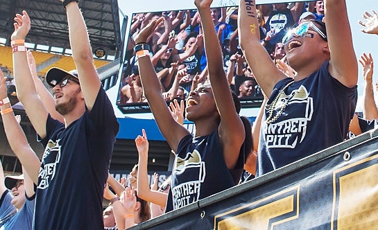 Students cheering on Pitt football on game day