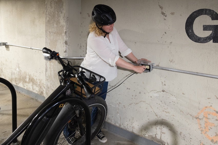 Woman plugging in e-bike to charge