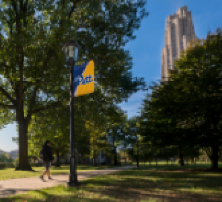 Student walking near the Cathedral of Learning