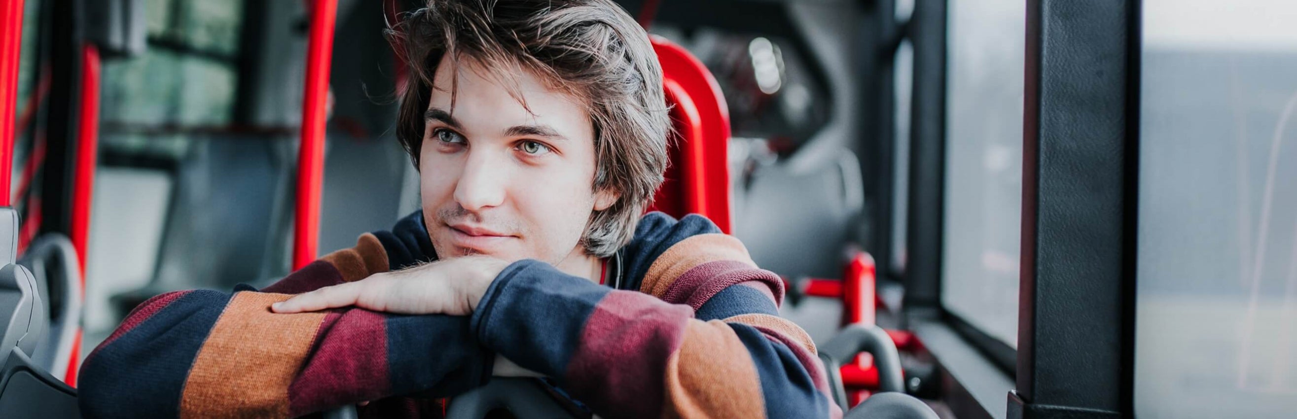 Male student sitting on bus
