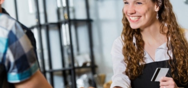 Dining hall associate smiling with ID card