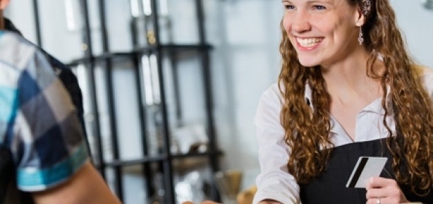 Dining hall associate smiling with ID card